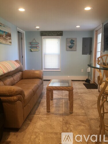 A living room with a couch, chair, and coffee table.