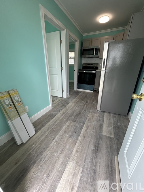 A kitchen with a refrigerator, oven, and microwave.
