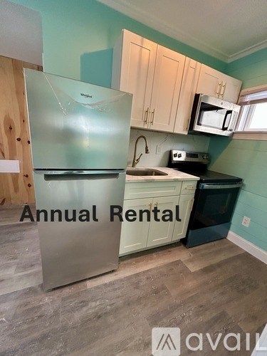 A kitchen with a refrigerator, microwave, and toaster oven is available for annual rent.