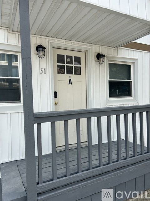 A white door with a black handle and a number 51 on it.