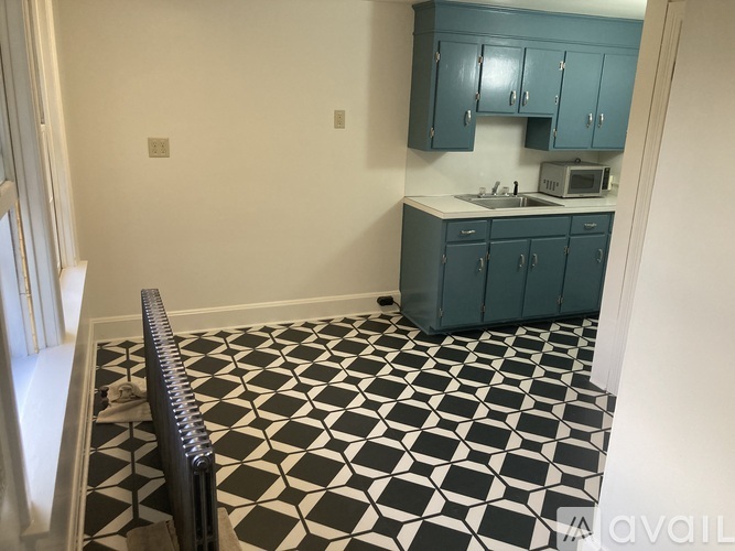 A kitchen with a black and white checkered floor.