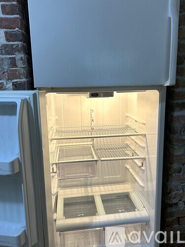 A white refrigerator with its door open and shelves visible.