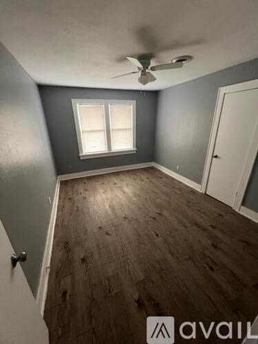 A room with a ceiling fan and a window.