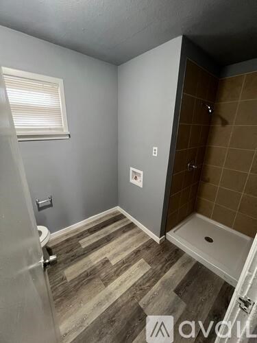 A bathroom with a toilet, a sink, and a shower.