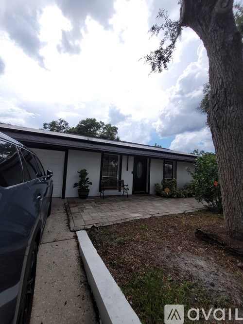 A house with a car parked in front.
