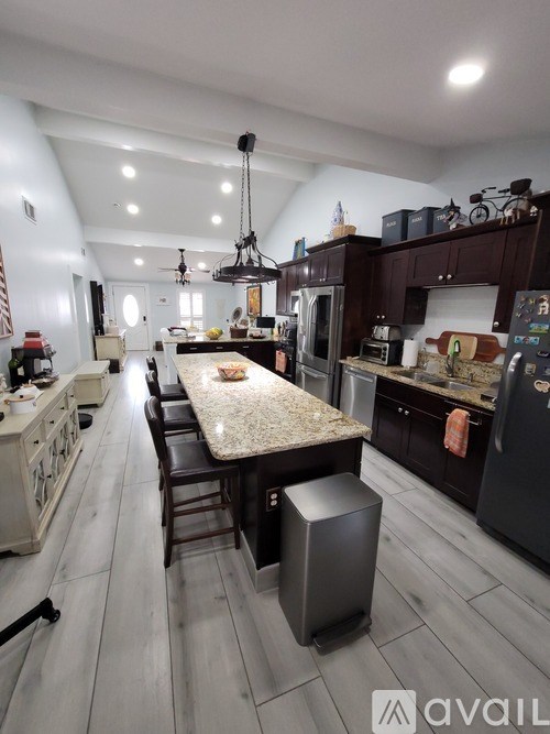 A kitchen with a table and chairs in the middle of the room.