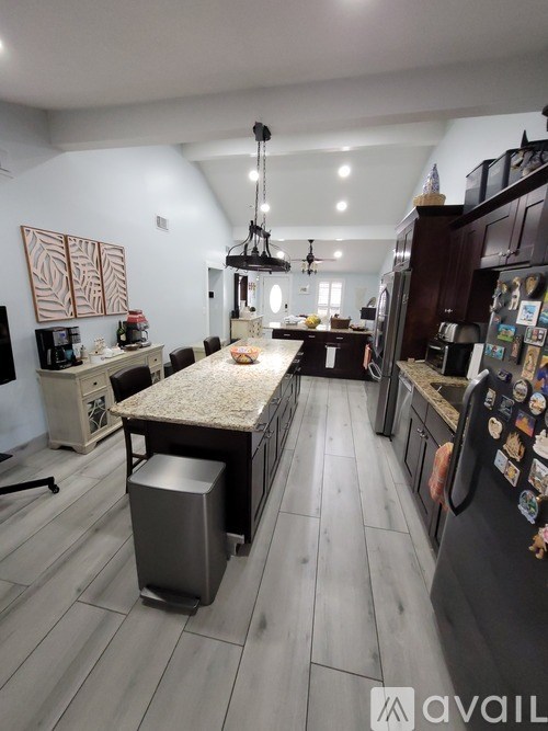A kitchen with a table and chairs in the middle of the room.