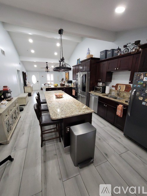 A kitchen with a large island in the middle of the room.