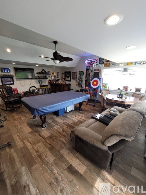 A room with a blue table and a brown couch.