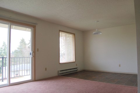 A room with a sliding glass door and a window.