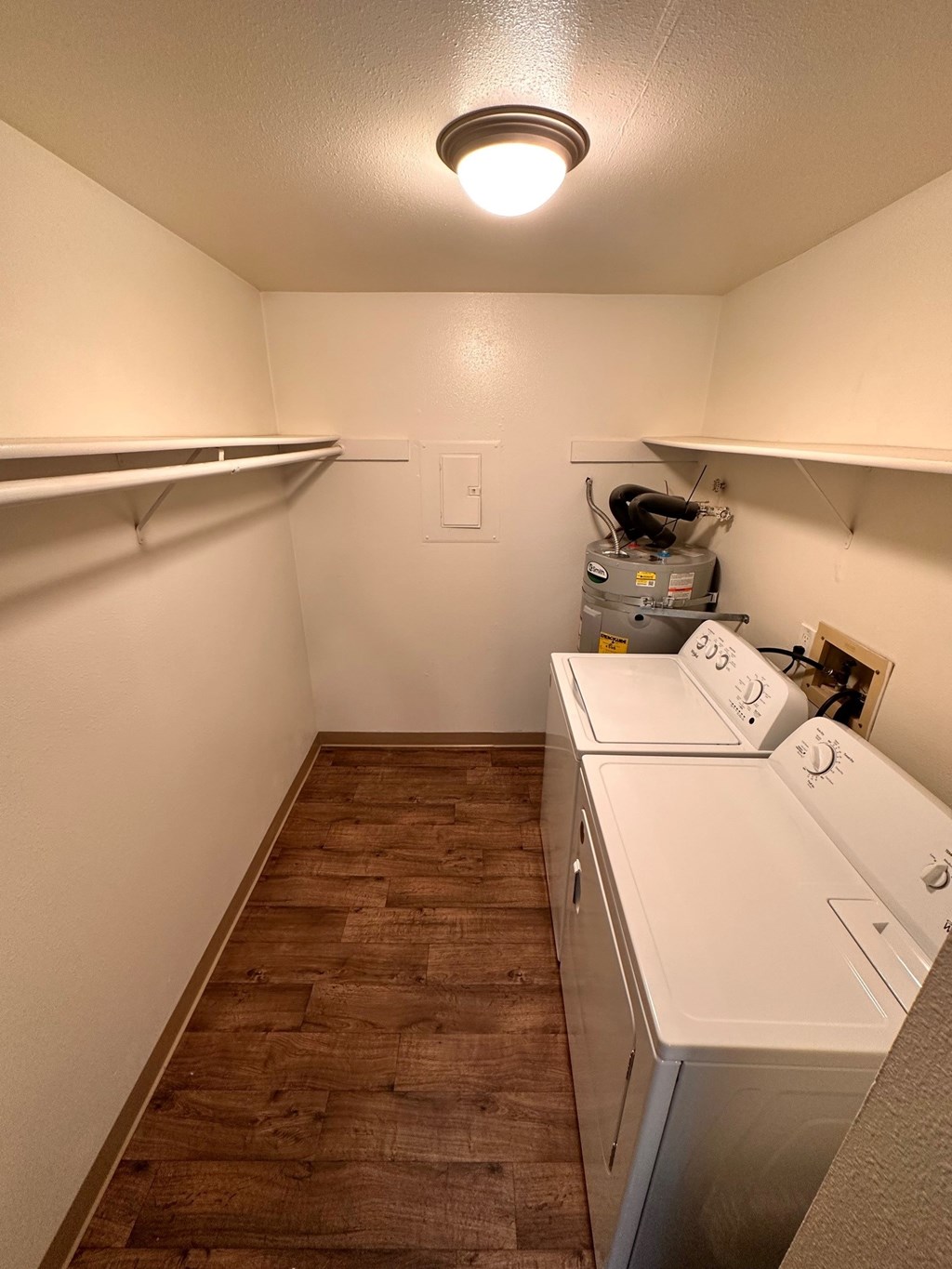A small laundry room with a washer and dryer.