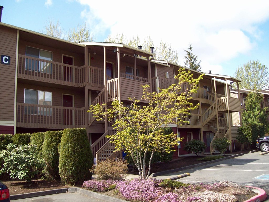 Apartment complex with a tree in front.