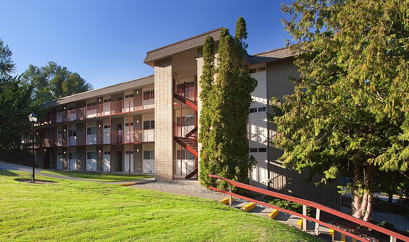 A large building with a red fence in front of it.