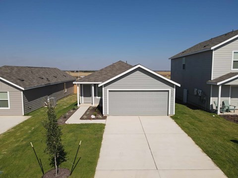 A residential area with houses and a clear sky.