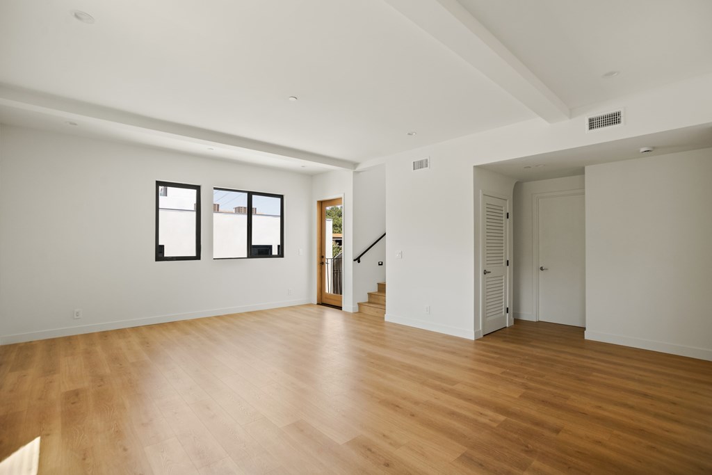 A room with wooden floors and white walls.