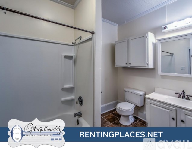 A bathroom with a toilet, sink, and shower.