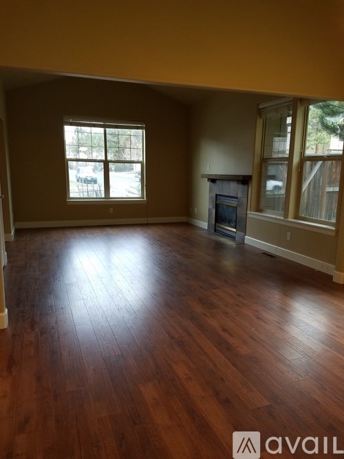 A room with wooden floors and a fireplace.