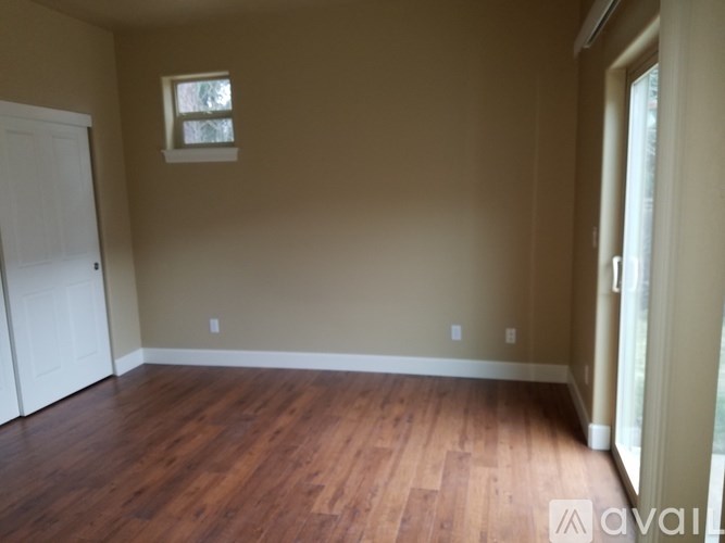A room with wooden floors and a window.