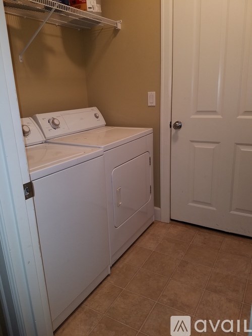 A small laundry room with a washer and dryer.
