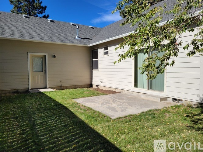 A house with a brown door and a green window.
