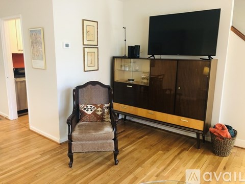 A living room with a chair and a cabinet.