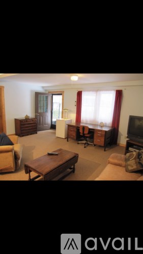 A living room with a brown couch and a wooden coffee table.