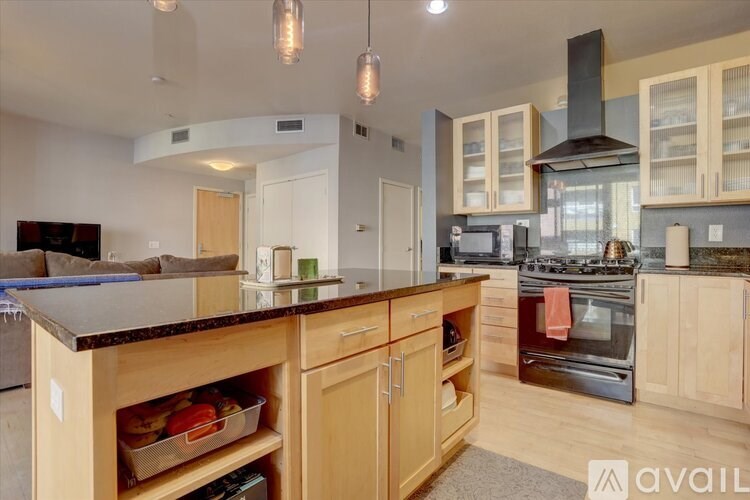 A kitchen with wooden cabinets and a dark countertop.