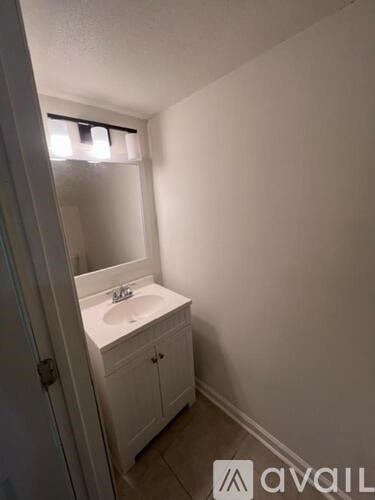 A bathroom with a sink and a mirror.
