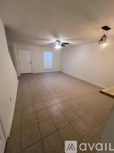 A room with tiled flooring and a ceiling fan.