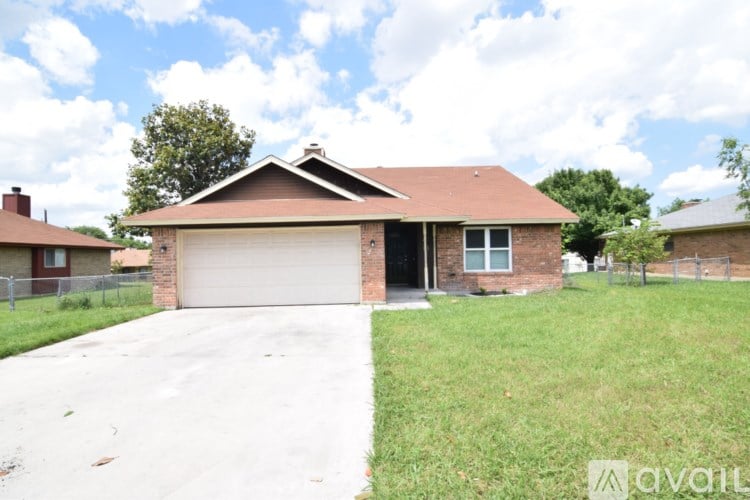 A house with a brown roof and a garage door is for sale.