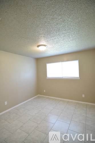 A room with a window and tiled floor.