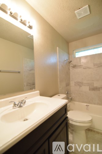 A bathroom with a sink, toilet and bathtub.