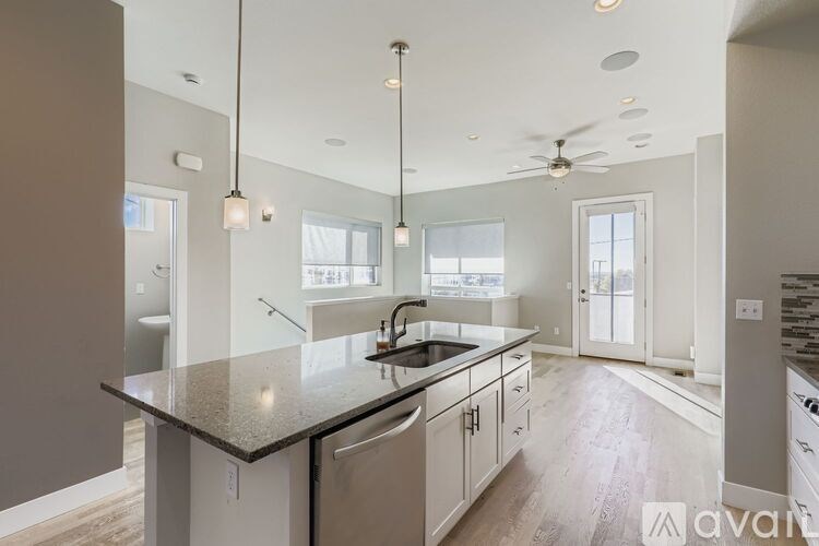 A small bathroom with a toilet and a picture on the wall.
