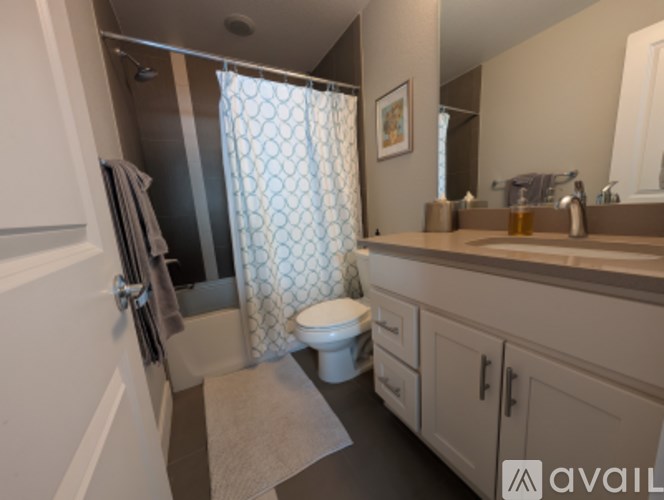 A bathroom with a toilet, sink, and shower.