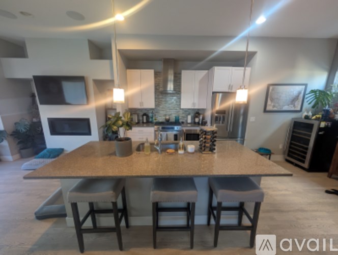 A kitchen with a table and chairs in the foreground.