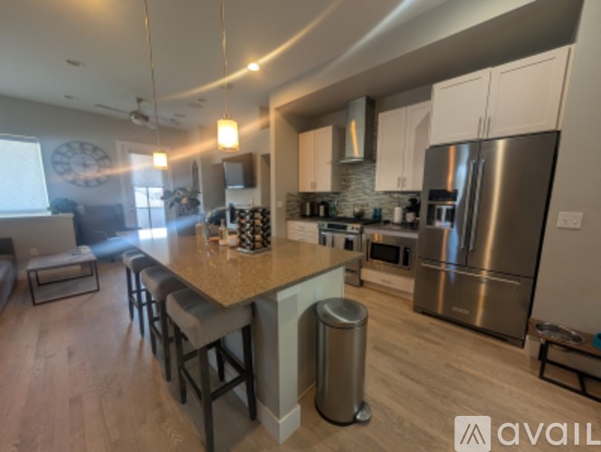 A kitchen with a large island and stainless steel appliances.