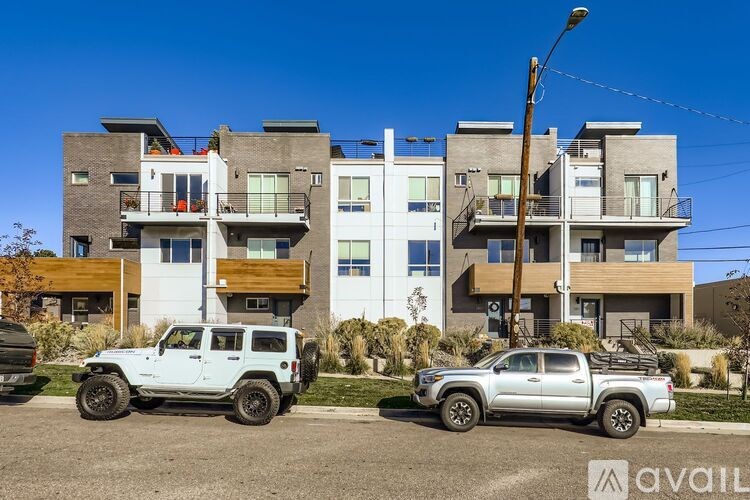 A modern multi-story building with a balcony on the second floor.