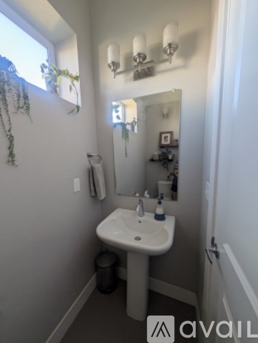 A bathroom with a sink and mirror.