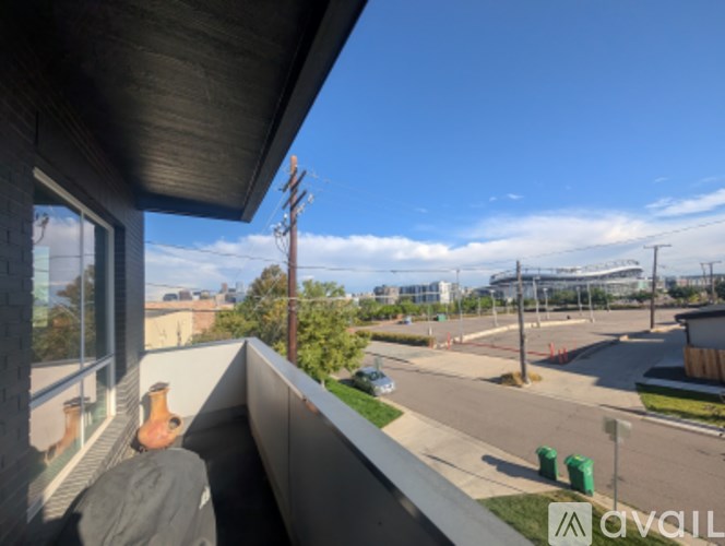 A view from a balcony overlooking a parking lot.