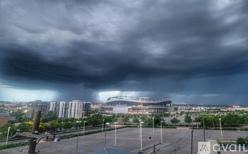 A dark stormy sky looms over a cityscape.
