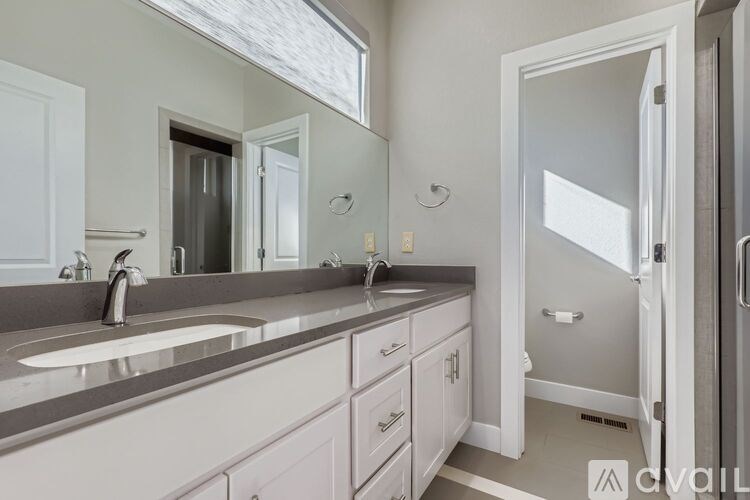 A balcony with a chair and a view of the city.