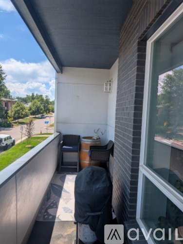 A balcony with a chair and a table.