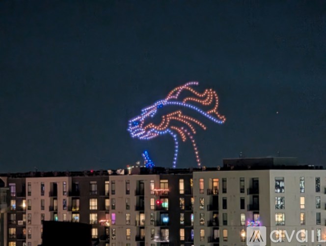 A building with a lighted sign that says "AVGIL".