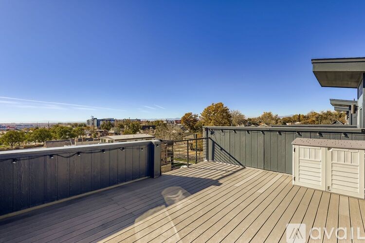 A wooden deck with a metal roof and a shed.