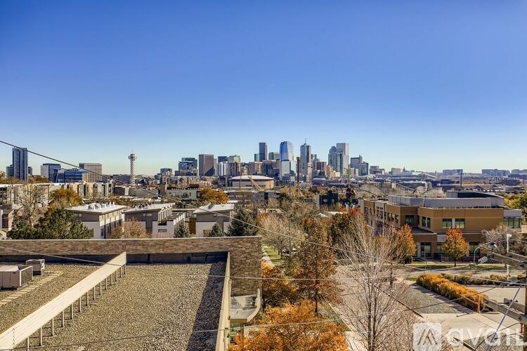 A cityscape with a clear blue sky above it.