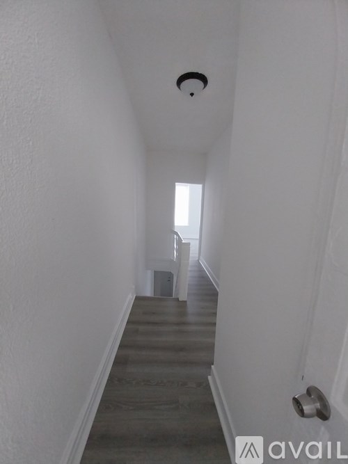 A long hallway with a light at the end.