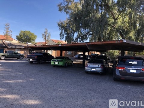 A parking lot with cars and a building in the background.