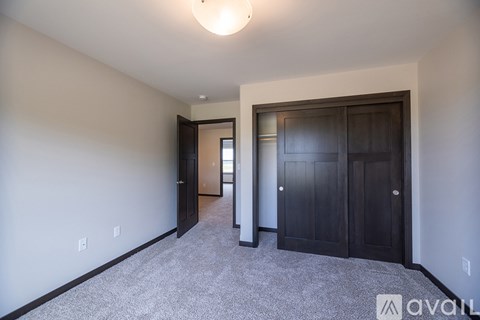 A spacious room with a carpeted floor and a ceiling light.