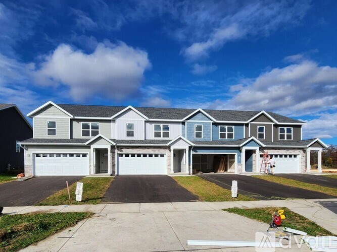 A large two-story house with a garage on the ground floor.