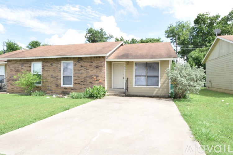 A house with a brown roof and a beige garage door.